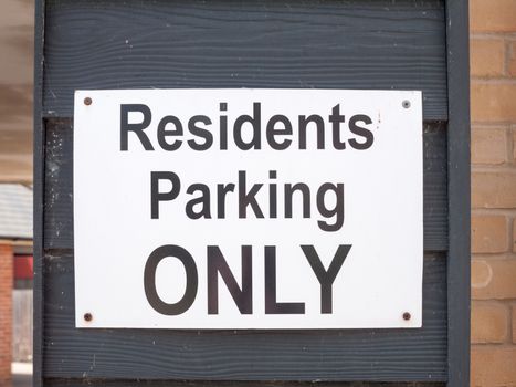 a black and white residents parking only sign