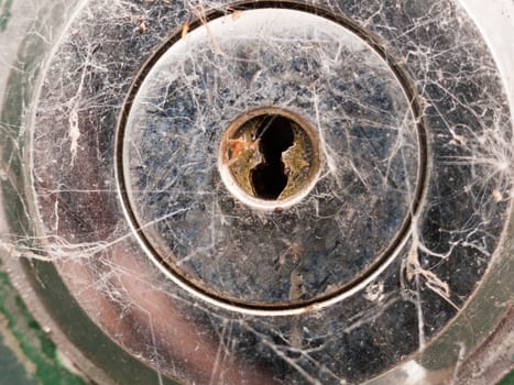 a silver metal key hole up close locked for graphic design safety and crime