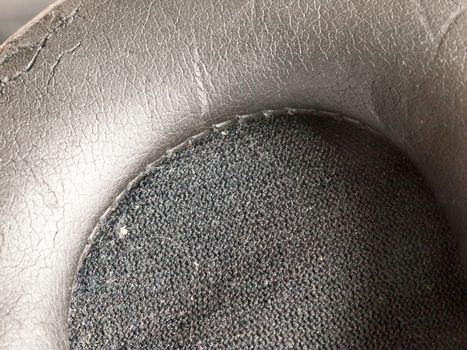 black texture of a headphone earbud up close macro