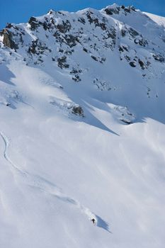 Skier carving through powder snow