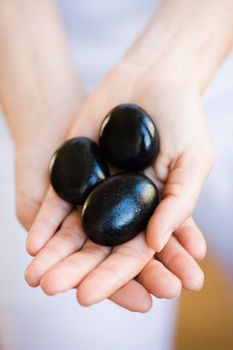 Hands holding hot stones