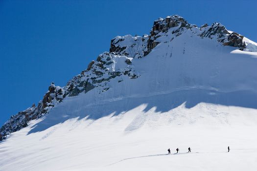 Silhouetted ski tourers on the mountain