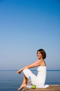 Woman sitting on a pier