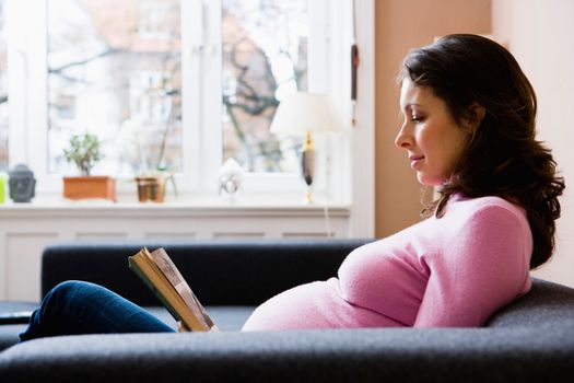 Pregnant woman reading a book