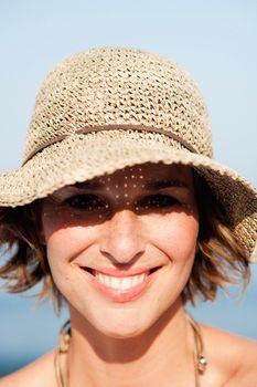 Woman with hat smiling