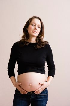 Pregnant woman holding her belly