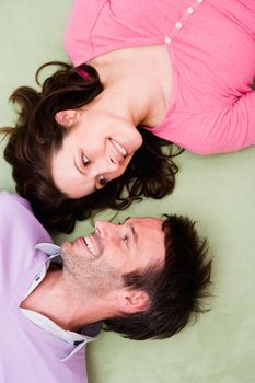Young couple laying on carpet