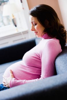 Pregnant woman sitting on couch