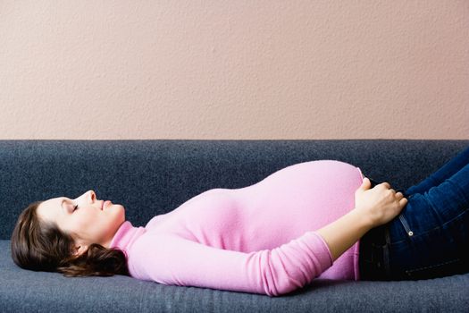 Pregnant woman laying on couch