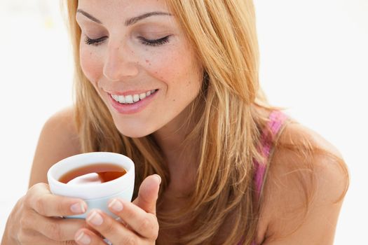 young woman enjoying cup of tea