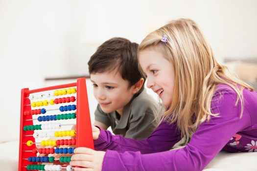 brother and sister playing with abacus