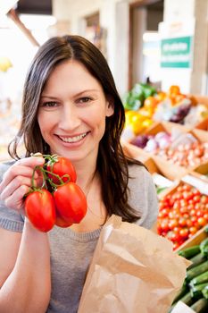 Woman showing fresh tomatoes