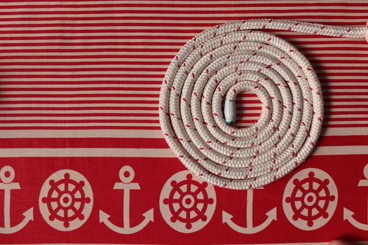 Rope round spiral red striped  flat lay Marine background