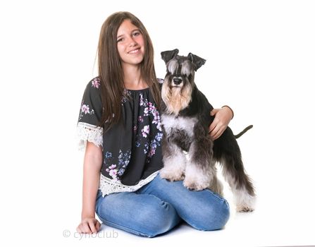teenager and miniature schnauzer in front of white background