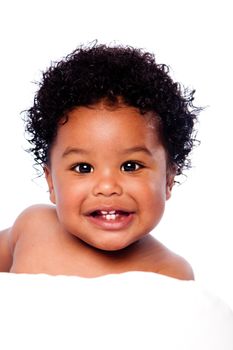 Happy smiling cute adorable teething baby face showing milk teeth, with curly hair.
