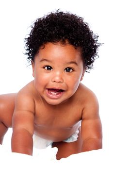 Happy smiling cute adorable teething baby face showing milk teeth, with curly hair, crawling.