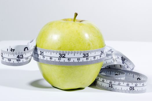 fresh apple with measuring tape. diet concept, loss weight