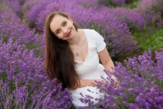 Smiling woman among lavender field blossom