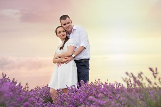 Lovely beautiful couple hugging in lavender flowers