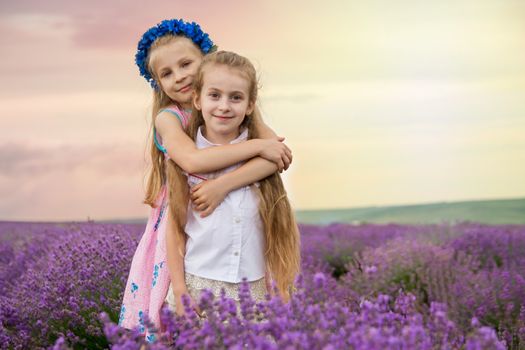 Two cute girls hugging omong lavender field