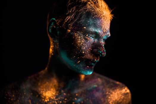 Conceptual shot of light and shine fluorescent  colors young man's face