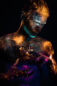 Conceptual shot of light and shine fluorescent  colors young man's face