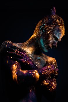 Conceptual shot of light and shine fluorescent  colors young man's face