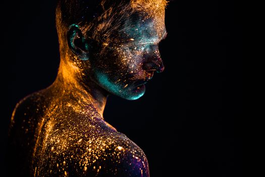 Conceptual shot of light and shine fluorescent  colors young man's face