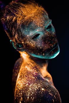 Conceptual shot of light and shine fluorescent  colors young man's face