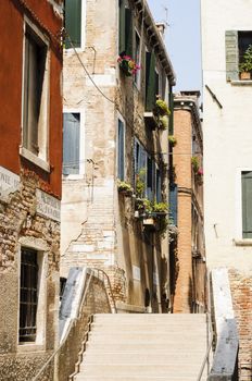 Narrow cobblestone alley in the historic centre of Venice, Veneto, Italy, Europe