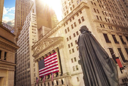 Famous Wall street and the building in New York, New York Stock Exchange with patriot flag