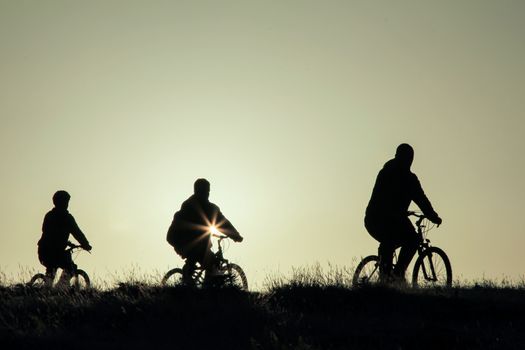 silhouette of a bike trip group