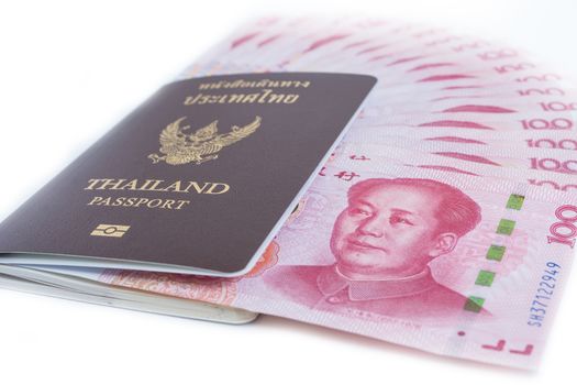 Yuan banknotes from China's currency and thailand passport ready to travel . Chinese banknotes isolated on white background.