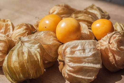 Cape gooseberry (Physalis) on wooden table, healthy fruit and vegetable