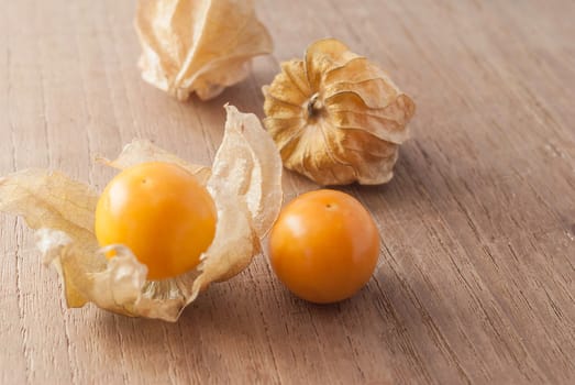 Cape gooseberry (Physalis) on wooden table, healthy fruit and vegetable