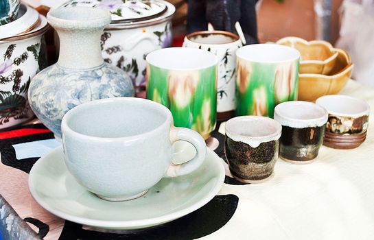 enamel plates, bowls and mugs stacked