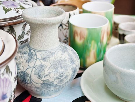 enamel plates, bowls and mugs stacked