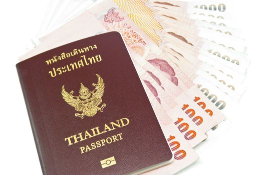 Thailand passport with Thai money ready to travel on white background