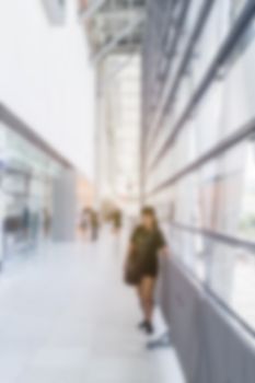 abstract image of woman in town in the rush hour of a modern business center with a blurred background