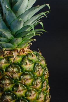 pineapple fruit closeup on black background, closeup