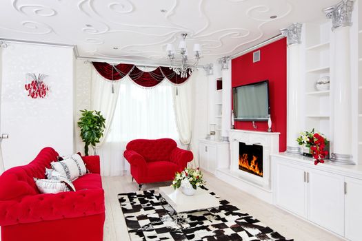 Classical living room interior in white and red with fireplace and columns