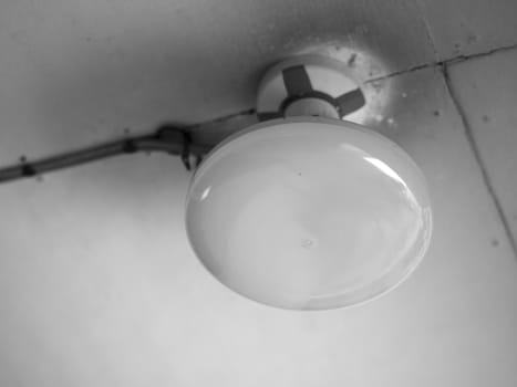 BLACK AND WHITE PHOTO OF CLOSE-UP OF ROUNDED CEILING LIGHT