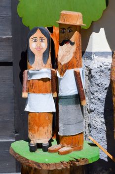 Elderly couple replicated in tree trunks of tyrol in Austria