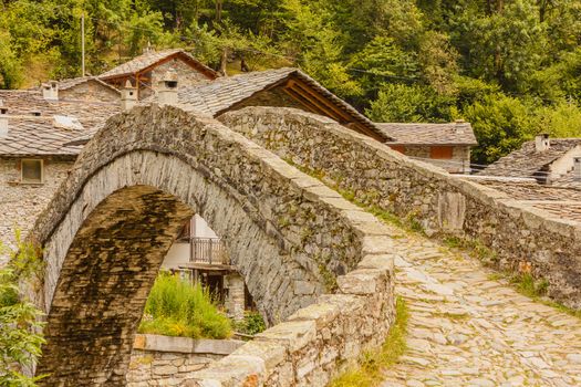 a romanesque bridge made of donkey back of  of the 17th century, at the entrance to the village of Fondo ,in Piedmont,Italy