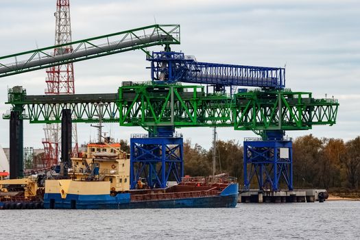 Blue cargo ship loading in the port of Riga, Europe