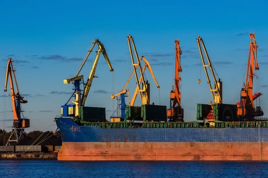 Blue cargo ship loading in the port of Riga, Europe