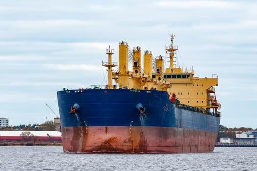 Blue cargo ship entering the port of Riga, Europe