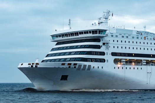 White cruise liner. Passenger ferry moving in still water