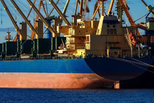 Blue cargo ship loading in the port of Riga, Europe