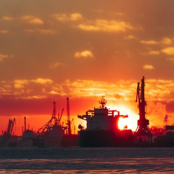 Colorful winter sunrise against the cargo port